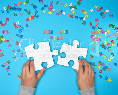 women hand hold  large white puzzles and the inscription join ou