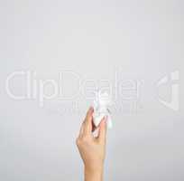 female hand holding white crumpled paper