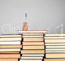 stack of different books on a gray background