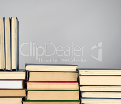 stack of different books on a gray background