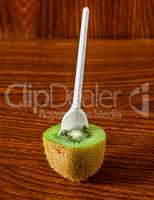 Half a kiwi with a spoon