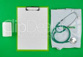 paper holder with empty white sheets, medical stethoscope