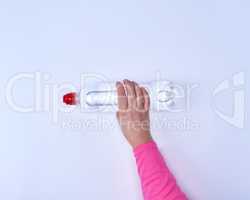 transparent plastic bottle with fresh water in a female hand