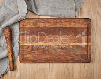 Empty old wooden kitchen cutting board and a gray towel