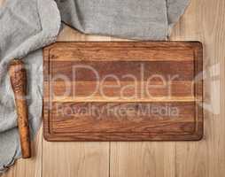 Empty old wooden kitchen cutting board and a gray towel