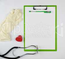 medical stethoscope and green paper holder