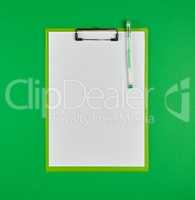 paper clipboard and pen on a green background