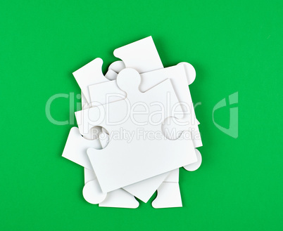 blank white big puzzles on green background