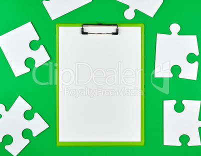 paper clip and white large paper puzzles