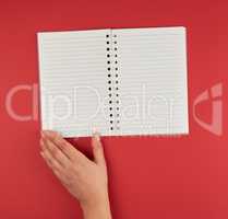 empty open notebook  and a female hand