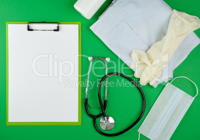 paper holder with empty white sheets, medical stethoscope