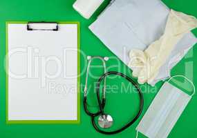 paper holder with empty white sheets, medical stethoscope