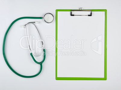 empty white sheets and medical stethoscope on a white background