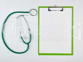 empty white sheets and medical stethoscope on a white background