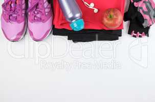 women's sportswear for fitness,  bottle, headphones and sneakers