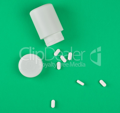 white plastic can and scattered oval pills