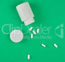 white plastic can and scattered oval pills