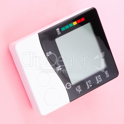 blood pressure monitor on pink background