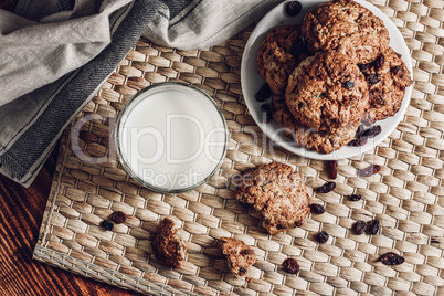 Glass of Milk and Oatmeal Cookies on White Plate