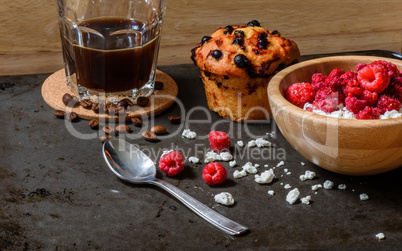 Cottage cheese with raspberries, coffee in a cup and blueberry muffin
