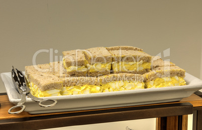 Egg salad sandwich with the crust at a lunch buffet