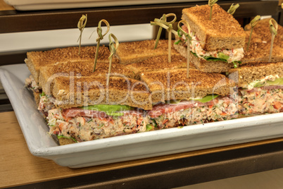 Lobster salad sandwich with avocado and the crust at a lunch buf
