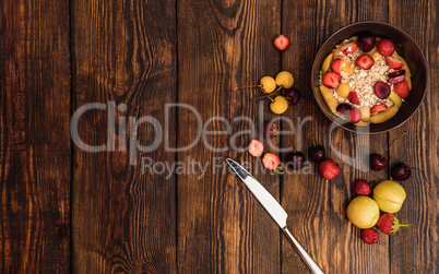 Breakfast with porridge, sweet fruits and berries