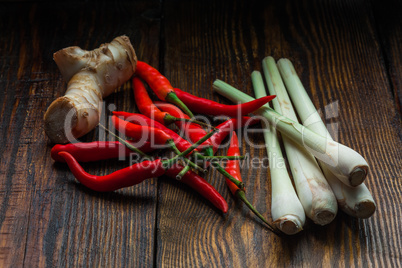 Galangal root, Mexican chili peppers with lemongrass on wooden table