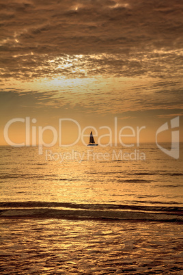 Sailboat against the golden sky of South Marco Island Beach at S