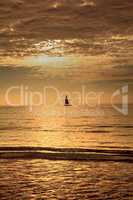 Sailboat against the golden sky of South Marco Island Beach at S