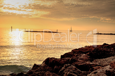 Sailboat against the golden sky of South Marco Island Beach at S
