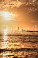 Sailboat against the golden sky of South Marco Island Beach at S