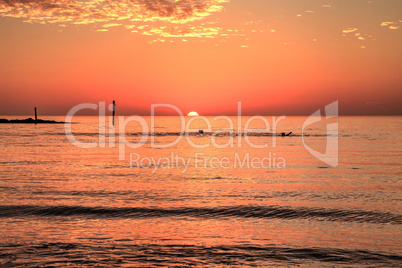 Swim at sunset with a red sky over South Marco Island Beach
