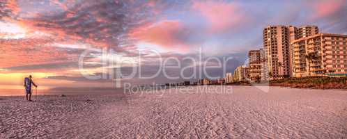 Old man at sunset with a pink and golden sky over South Marco Is