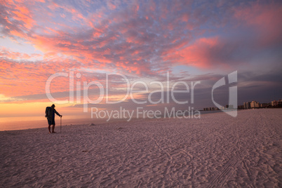 Old man at sunset with a pink and golden sky over South Marco Is