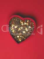 Red heart shaped gift box with golden decoration