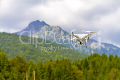 White drone flying above mountains