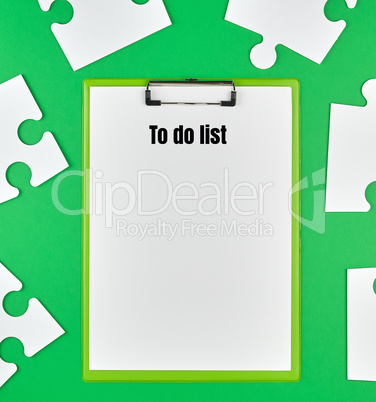paper clip and white large paper puzzles