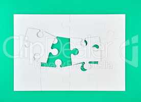 big paper puzzles on a green background