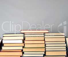 stack of different books on a gray background