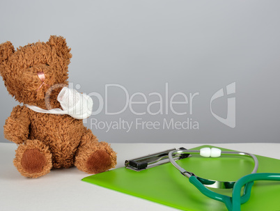medical stethoscope and green paper holder