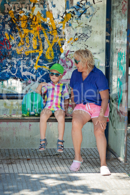 Multicolor beach people at a bus stop