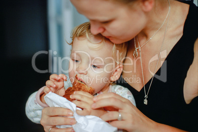Feeding a baby with pastry