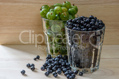 Blueberries and gooseberries in glass