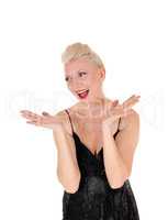 A happy laughing blond woman with her hands up