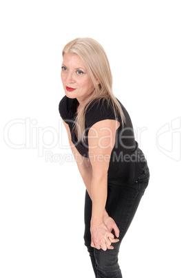 A happy looking blond woman standing in black outfit