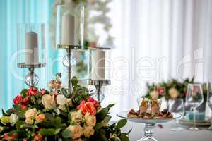 Candles and flowers on festive table