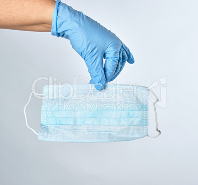 hand holding a medical mask