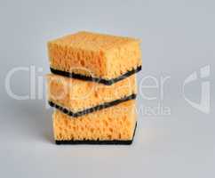 stack of yellow kitchen sponges for washing dishes