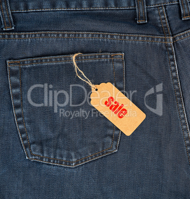 brown paper tag on a rope tied to blue jeans